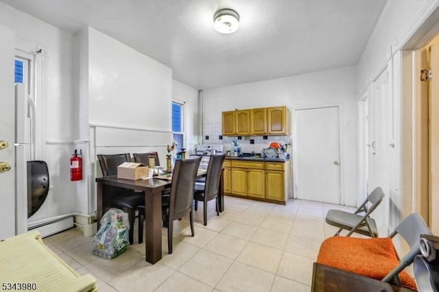 dining room with light tile patterned flooring and a baseboard radiator