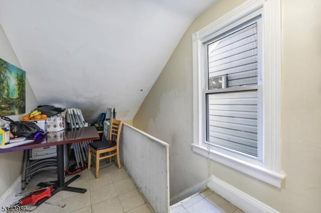 tiled home office with lofted ceiling and baseboards