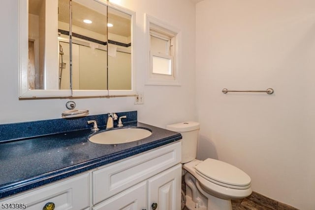 half bathroom with toilet and vanity