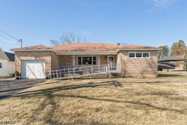 519 Lynda Rd, Lopatcong Twp, NJ 08865 - ranch-style house featuring a porch, a front yard, driveway, and a garage