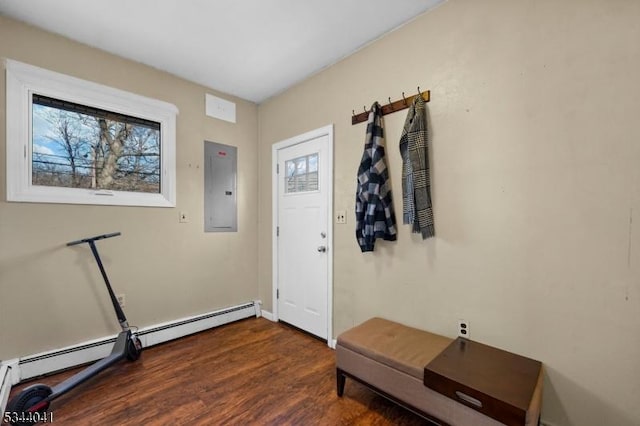 entryway with electric panel, a baseboard heating unit, a wealth of natural light, and wood finished floors