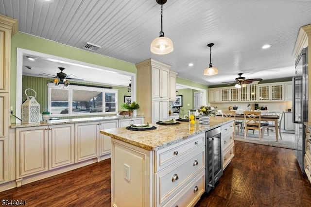 kitchen featuring wine cooler, visible vents, cream cabinets, and a ceiling fan