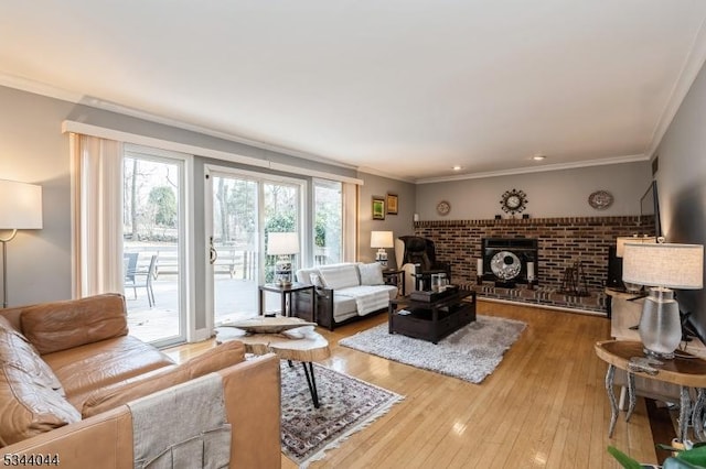 living area with hardwood / wood-style floors and ornamental molding