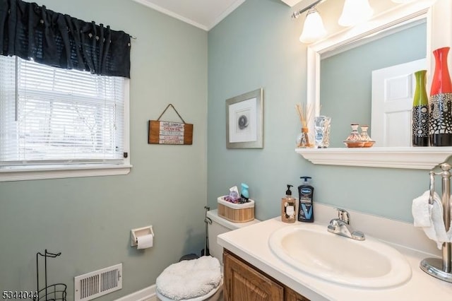 half bath with visible vents, toilet, and vanity