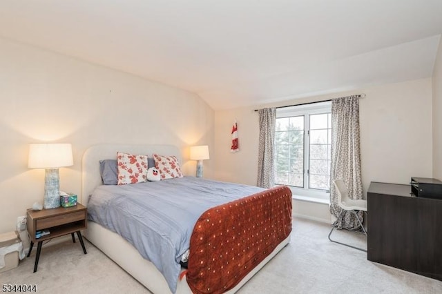 carpeted bedroom featuring lofted ceiling