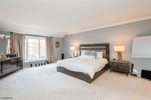 carpeted bedroom featuring crown molding, baseboards, and vaulted ceiling