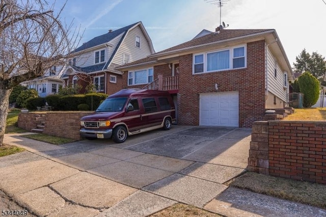 view of front facade featuring brick siding, driveway, and a garage