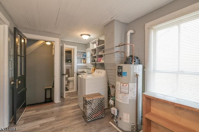 utility room with gas water heater and washing machine and clothes dryer