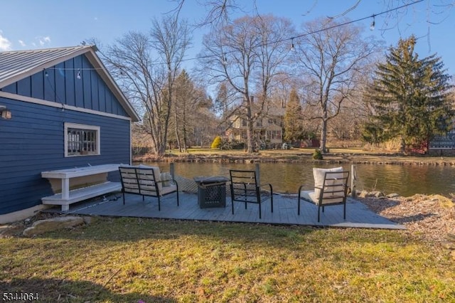 exterior space featuring a lawn and a water view