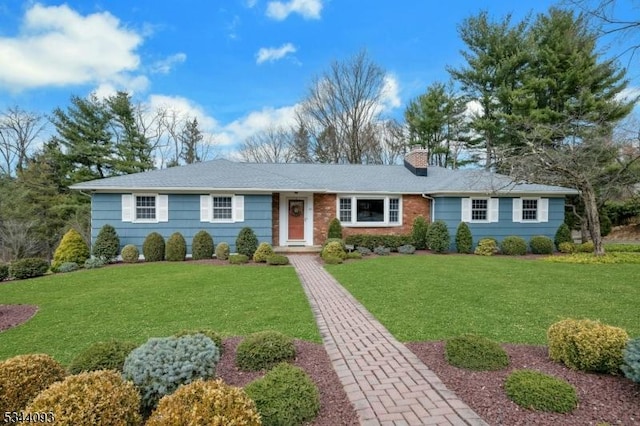 ranch-style home featuring a chimney and a front yard