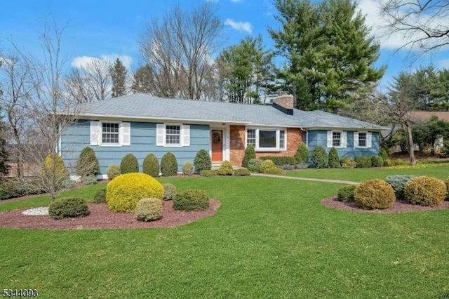 single story home featuring a chimney and a front yard