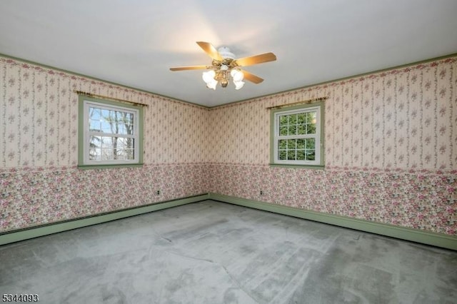 carpeted spare room with a baseboard radiator, ceiling fan, and wallpapered walls