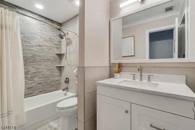 full bathroom featuring vanity, toilet, visible vents, and shower / bath combo