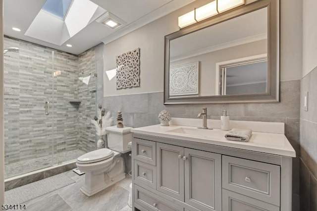 full bath featuring a shower stall, toilet, vanity, recessed lighting, and tile walls