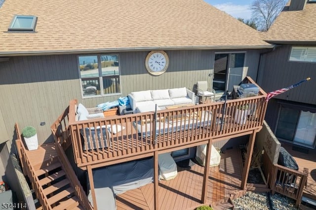 wooden deck featuring stairway and an outdoor living space