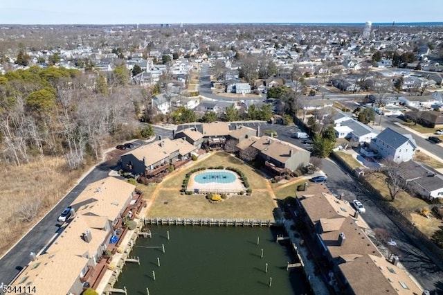 drone / aerial view featuring a residential view and a water view