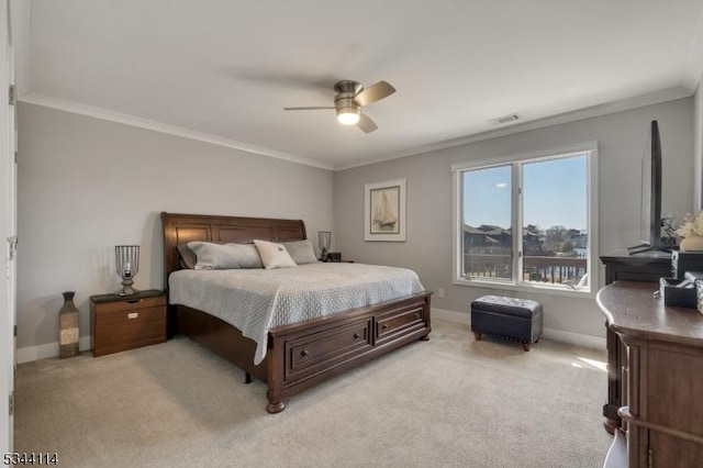 bedroom featuring a ceiling fan, baseboards, visible vents, light carpet, and crown molding