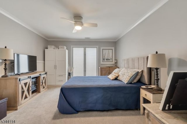 bedroom featuring light carpet, ornamental molding, and a ceiling fan