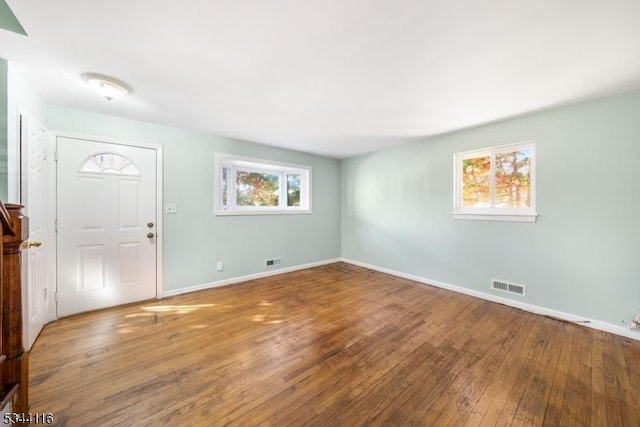 entryway featuring visible vents, baseboards, and wood-type flooring