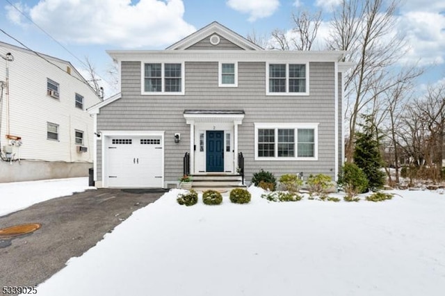 view of front of home featuring aphalt driveway and an attached garage