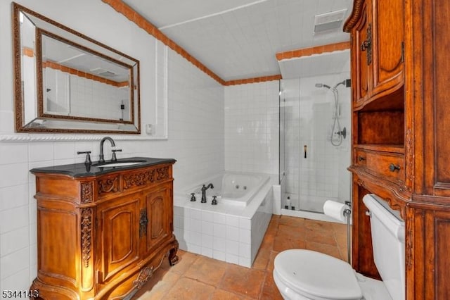 bathroom featuring a garden tub, vanity, toilet, tile walls, and a shower stall