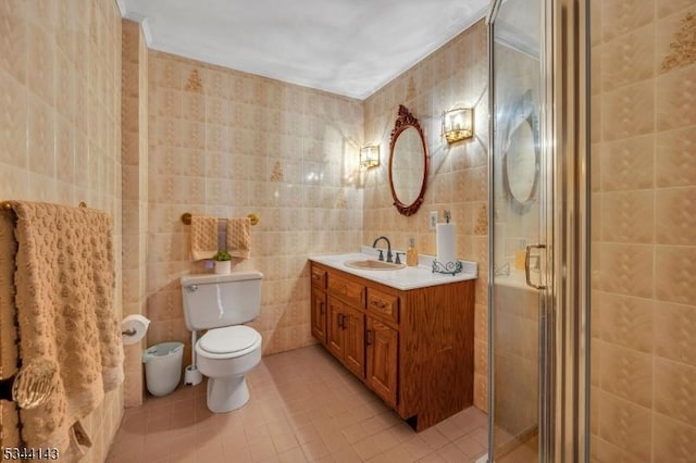 full bathroom with tile patterned flooring, vanity, toilet, tile walls, and a shower stall