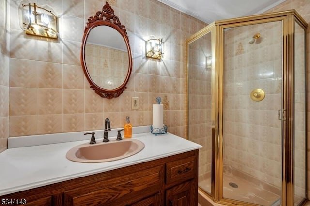 bathroom with vanity, tile walls, and a shower stall