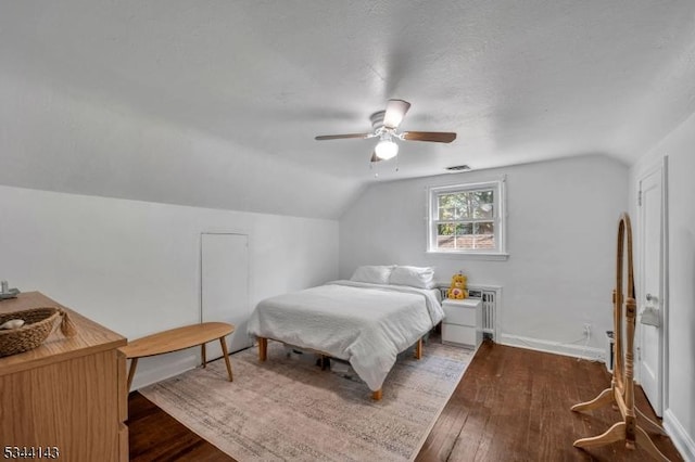 bedroom featuring ceiling fan, wood finished floors, and lofted ceiling