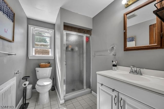 full bathroom featuring vanity, toilet, tile patterned floors, visible vents, and a stall shower