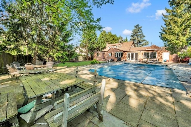 view of pool featuring fence, a fenced in pool, outdoor dining space, and a patio
