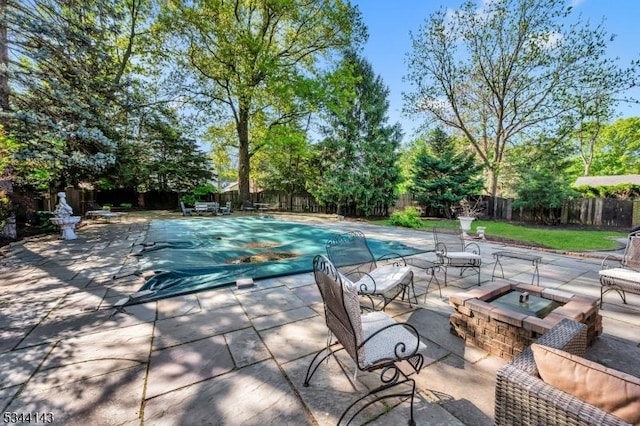 view of pool with a fenced backyard, a fenced in pool, and a patio