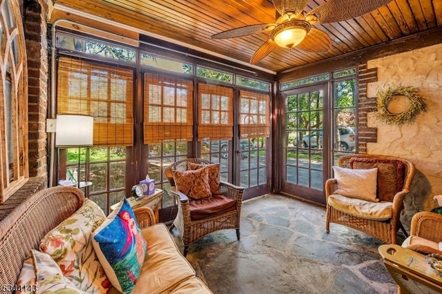 sunroom / solarium featuring wooden ceiling, french doors, and stone flooring