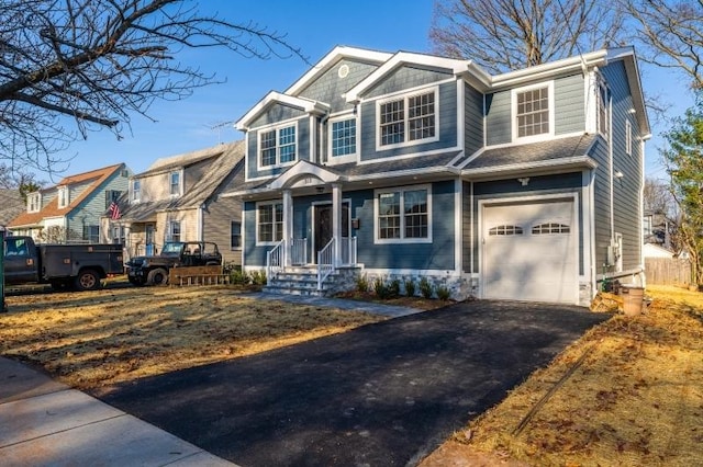 craftsman-style house with an attached garage and driveway