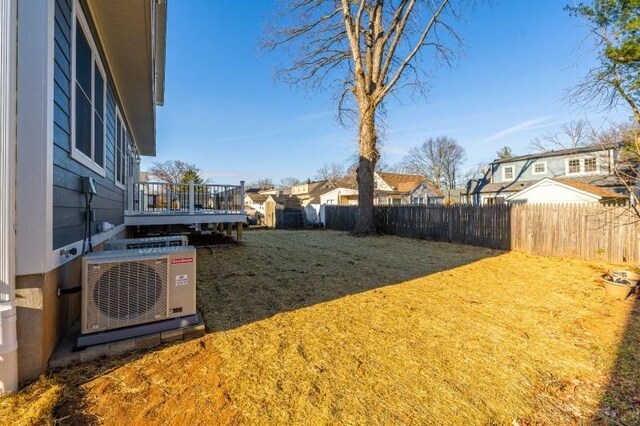 view of yard featuring ac unit, a residential view, and fence