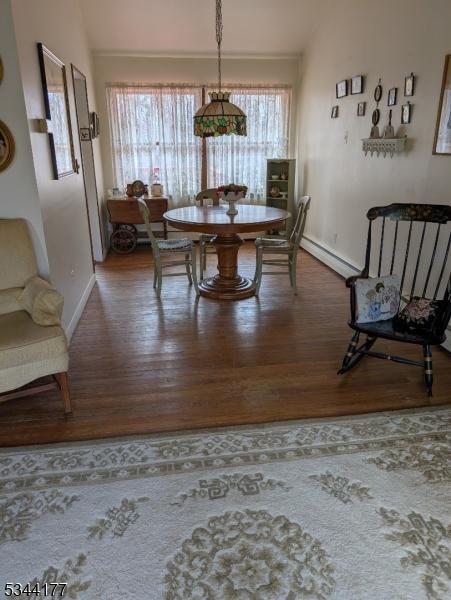 dining room with plenty of natural light, wood finished floors, and baseboards