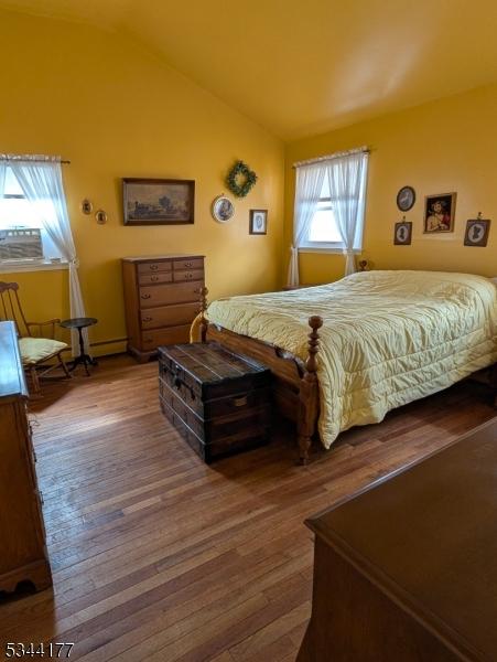 bedroom featuring vaulted ceiling and wood finished floors