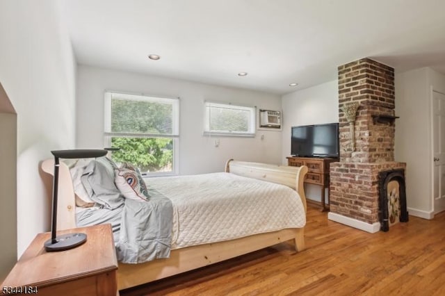 bedroom with wood finished floors and recessed lighting