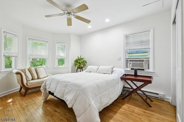 bedroom with cooling unit, light wood-type flooring, recessed lighting, a ceiling fan, and baseboards
