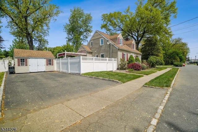 118 Indian Run Pkwy, Union Twp, NJ 07083 - view of side of home with fence, an outdoor structure, a yard, and a garage