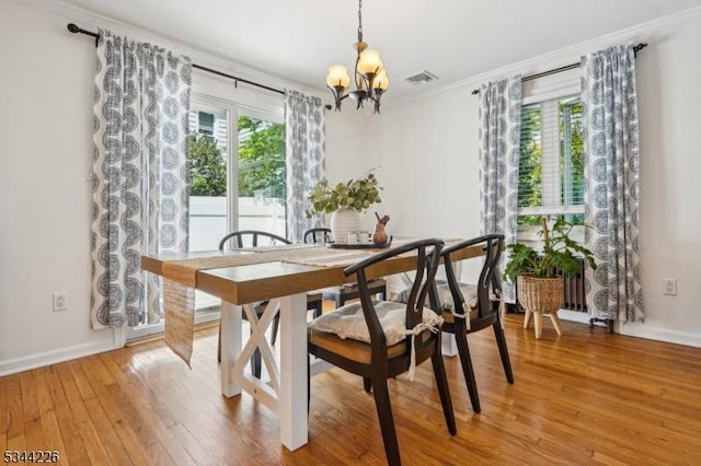 118 Indian Run Pkwy, Union Twp, NJ 07083 - dining space featuring visible vents, ornamental molding, baseboards, light wood-type flooring, and a notable chandelier