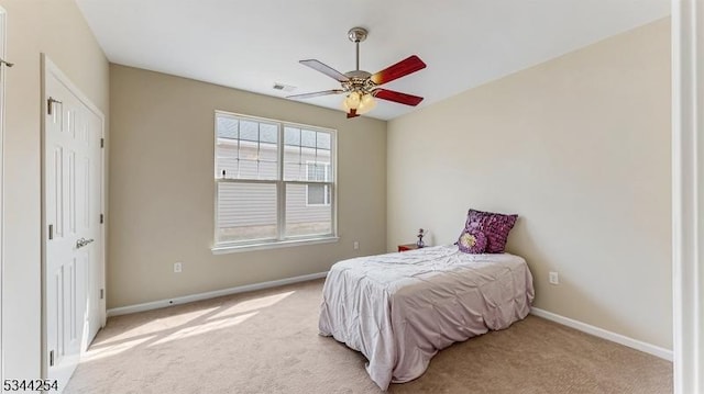 bedroom with light colored carpet, visible vents, and baseboards