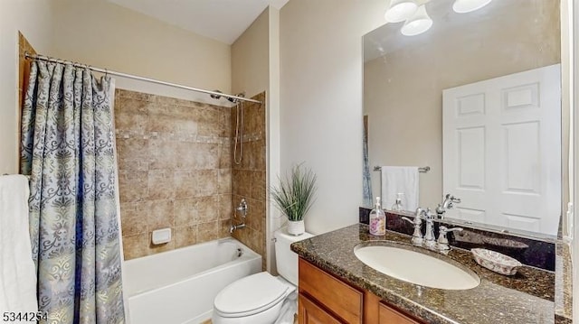 bathroom featuring vanity, toilet, and shower / tub combo with curtain