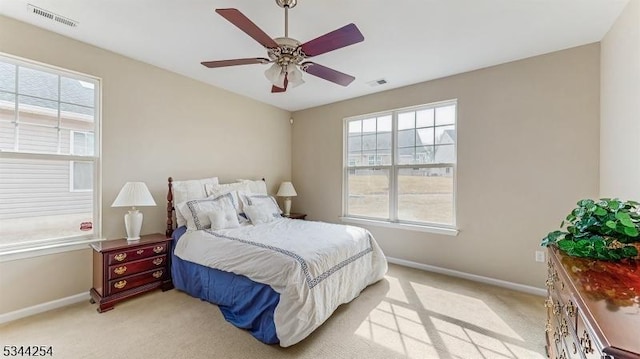 bedroom featuring visible vents, baseboards, and light colored carpet