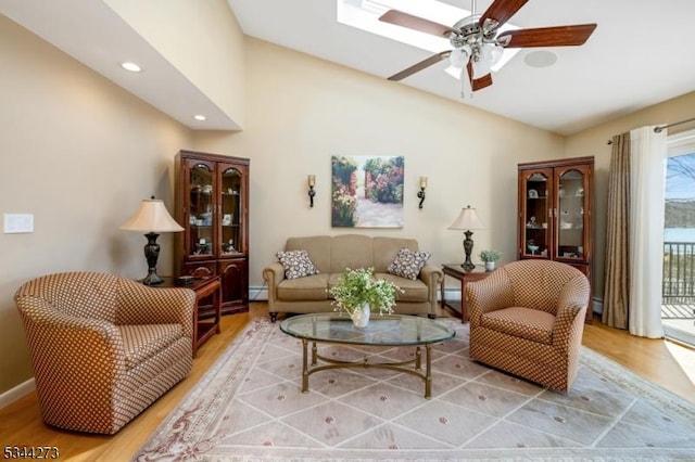 living area featuring light wood-style floors, a ceiling fan, recessed lighting, lofted ceiling, and baseboards