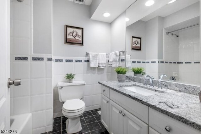 bathroom featuring tile walls, toilet, tile patterned flooring, and vanity