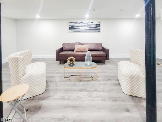 living area with visible vents, recessed lighting, baseboards, and wood finished floors