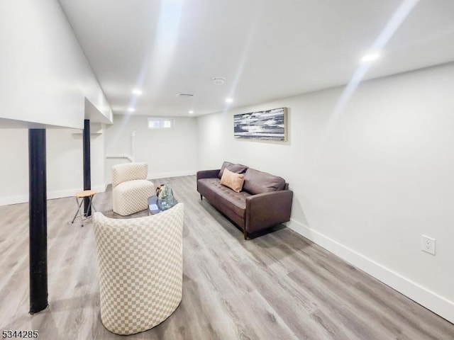 living area with recessed lighting, baseboards, and wood finished floors