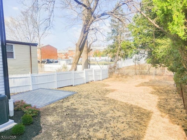 view of yard with a patio, cooling unit, and a fenced backyard