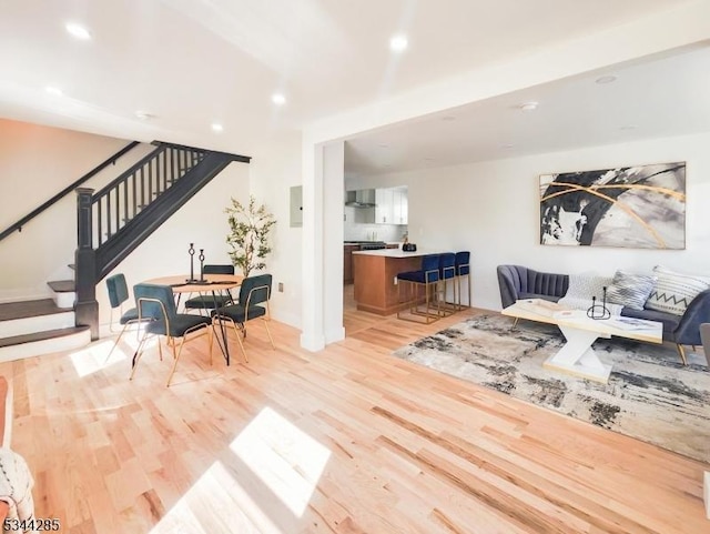 living area featuring stairs, recessed lighting, and light wood-style floors