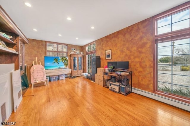 home office with recessed lighting, wood finished floors, and baseboard heating